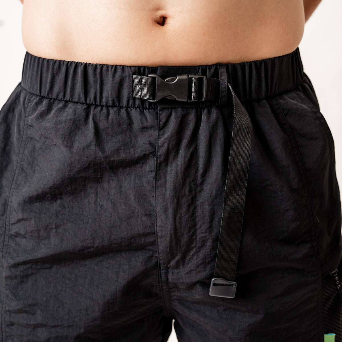 Compression button closure with integrated adjustable belt