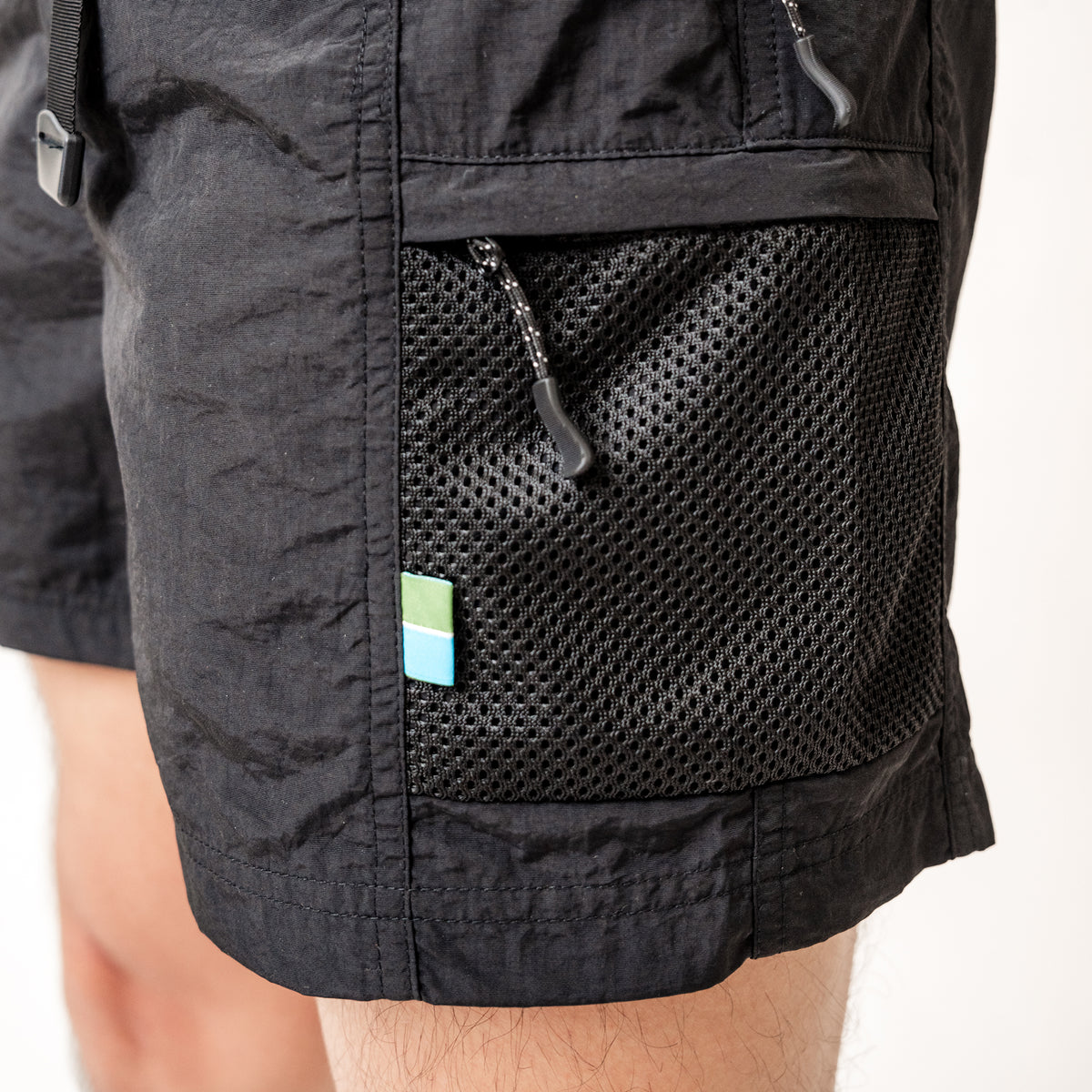 Two side pockets, two zip pockets with pull tags, one back pocket