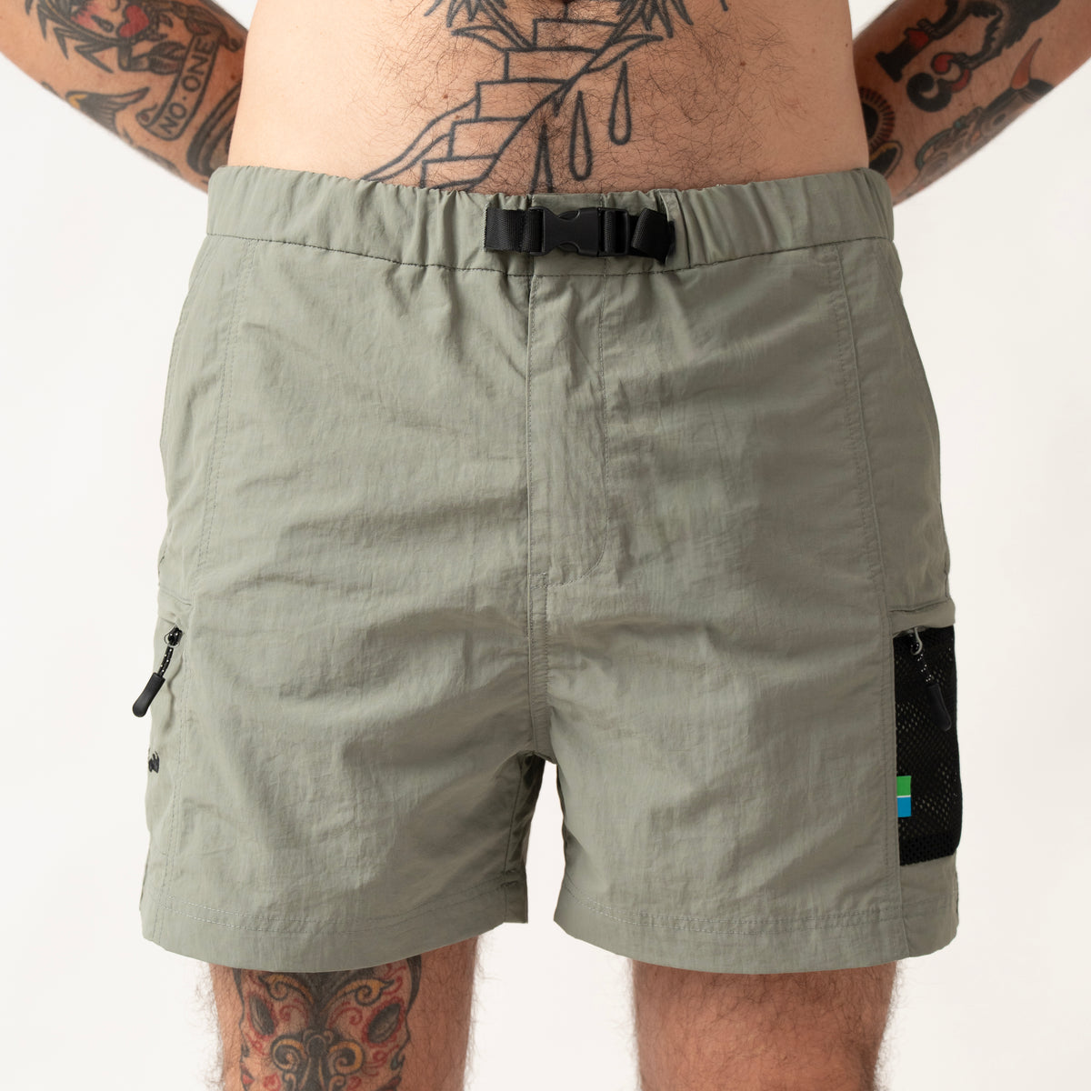 Compression button closure with integrated adjustable belt